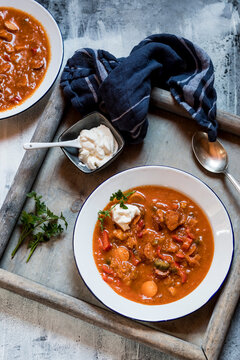 Bowl of ready-to-eat solyankasoup with sour cream and parsley