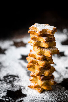 Studio shot of stack of star shaped cookies with powdered sugar