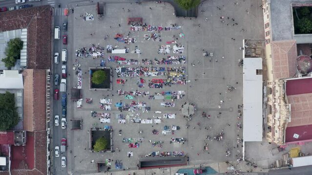 Aerial is showing busy market in front of diocesis de San Cristobal de las Casas, Static shot, Chiapas, Mexico