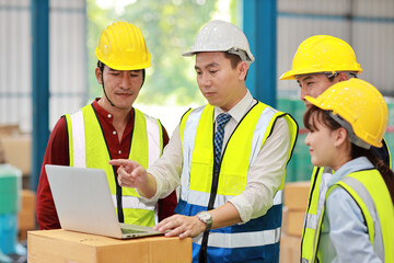 Group of technician engineer and businessman in protective uniform standing and discussing, researching, brainstorming and planning work with computer together at industry manufacturing factory