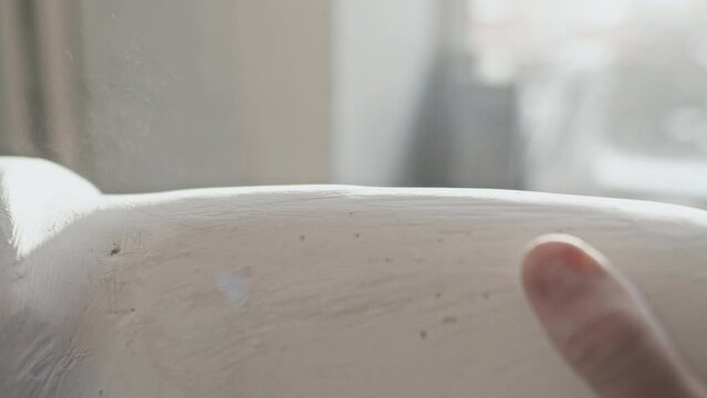 Close-up of unrecognizable man working in prosthetic production industry using sandpaper to polish plaster cast