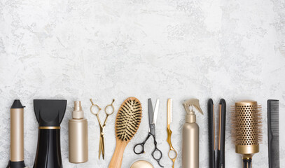 Collection of hairdresser tools on marble background with copy space