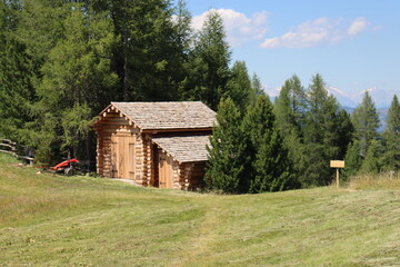 Val Badia, Italy-July 17, 2022: The italian Dolomites behind the small village of Corvara in summer days with beaitiful blue sky in the background. Green nature in the middle of the rocks.