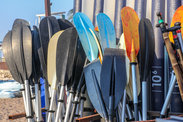 Plastic oars and paddle boards on the stack
