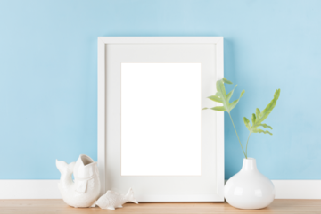 Elegant vertical white transparent picture frame with matte poster mockup and Japanese decoration in front of pastel blue wall.