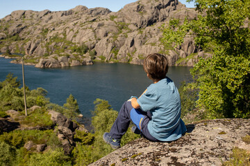 Naklejka premium Happy people, enjoying amazing views in South Norway coastline, fjords, lakes, beautiful nature