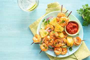 kebab skewers of barbecued shrimp with a pineapple