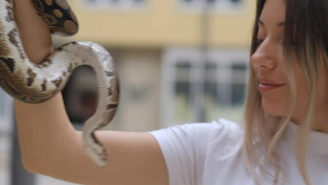 Young woman with a python snake