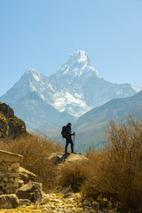 Man traveler with backpack enjoying the mountains in Himalayas. Everest base camp trek, Nepal.
