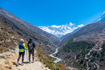 Fototapeta na wymiar A group of people trekking on dirt road in Nepal to Everest Base Camp