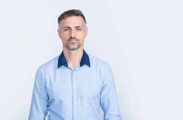 mature businessman in office shirt on grey background