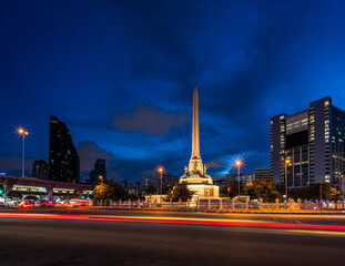 Trails of car lights and the Victory Monument in Bangkok at night