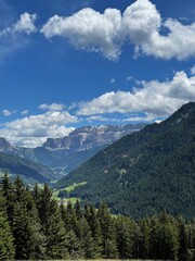 Obraz premium Scenic view of mountains, valley, forest, sky with clouds. Landscape