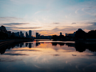 Fototapeta premium Sunset by the Kallang River in Singapore. Silhouette of residential apartment buildings in the background.