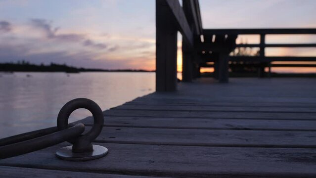 Peaceful evening sunset on pier in Oulu, Finland, focus on mooring ring