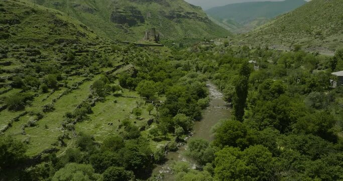 Pullback On Khertvisi Fortress With Flowing River And Vegetated Valleys In Southern Georgia. Aerial Shot