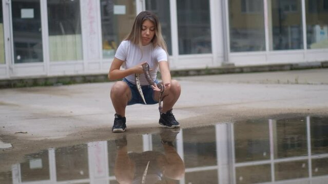 Young woman with a python snake