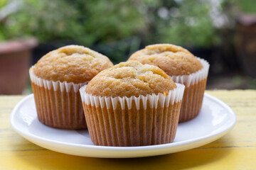 Sweet Banana muffins in white plate on the table.