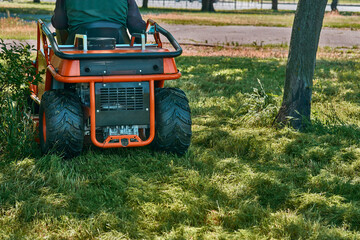 Professional grass cutting on lawns with a mini tractor lawn mower
