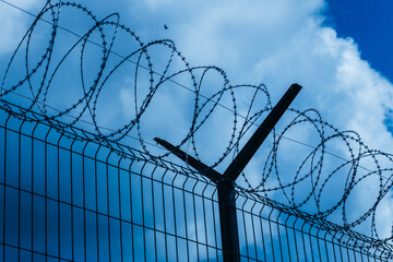 Barbed wire against the sky