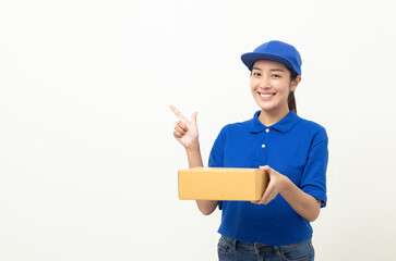 Happy delivery asian woman in blue uniform standing holding parcel cardboard box on isolated white background. Smiling female delivery sending box package service worker.