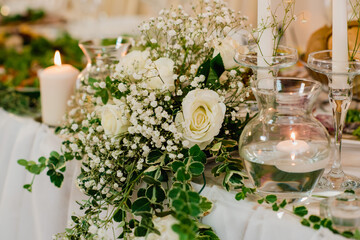 Wedding table decoration.Wedding flowers on the table. Decorating the table with flowers. Wedding decorations from flowers