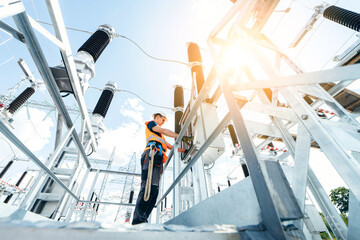 Adult electrical engineer inspect the electrical systems at the equipment control cabinet....