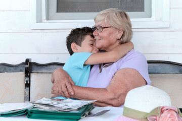 grandson hugs his grandmother at home. Happy family relationships, love, care. real people. - obrazy, fototapety, plakaty