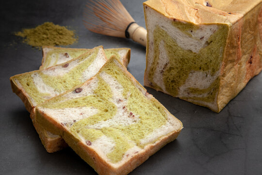 Marble Green Tea with red bean bread  on cement color background.