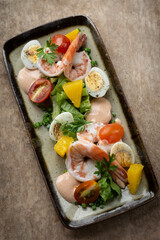 prawn and egg salad on rustic wood table