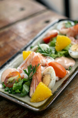 prawn and egg salad on rustic wood table