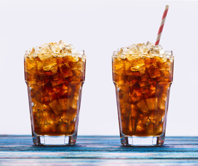 Alcoholic cocktail with rum and ice with the addition of cola in a glass, close-up