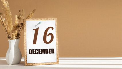 december 16. 16th day of month, calendar date.White vase with dead wood next to cork board with numbers. White-beige background with striped shadow. Concept of day of year, time planner, winter month
