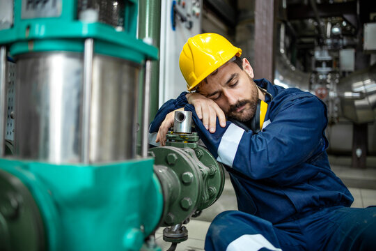 Tired Factory Worker Sleeping At Work During Night Shift.