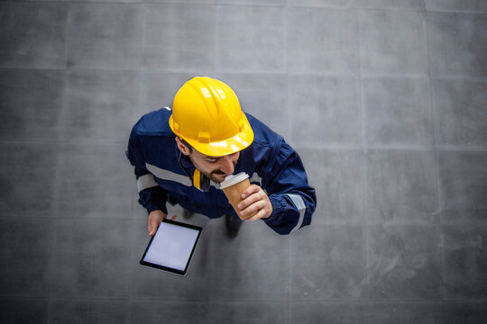 Factory worker on job break enjoying coffee time. - Powered by Adobe