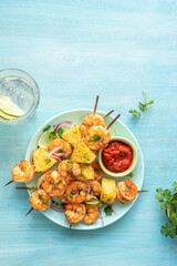 kebab skewers of barbecued shrimp with a pineapple