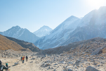 Tourist and porters walking on dirt road in Nepal to Everest Base Camp. Khumbu Glacier, way to Mt Everest base camp, Khumbu valley, Sagarmatha national park, Nepal.