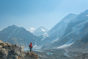 Female backpacker enjoying the view on mountain walk in Himalayas. Everest Base Camp trail route, Nepal trekking, Himalaya tourism.