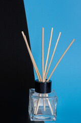 home diffuser with incense sticks on blue and black background