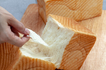 NAMA Shokupan or Japanese bread loaf on wooden board.