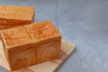 NAMA Shokupan or Japanese bread loaf on wooden board.