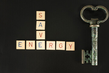 The word save and energy as a crossword puzzle made of wooden stones because saving energy is the...
