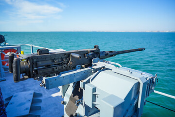 Automated machine gun on the deck of a military ship