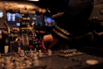 Female copilot switching control panel buttons on dashboard command, using radar compass on...