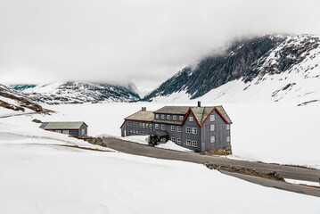Abandoned hotel, hut in winter mountains
