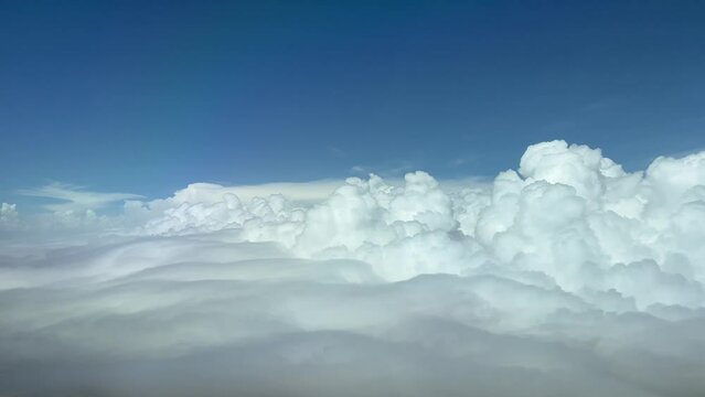 Aerial view of a cludy sky from above, flying at 10000 metres high. Pilot POV. 4K.