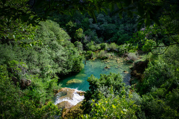 Fototapeta na wymiar Croatia, turquoise wellspring and waterfall hidden in the woods