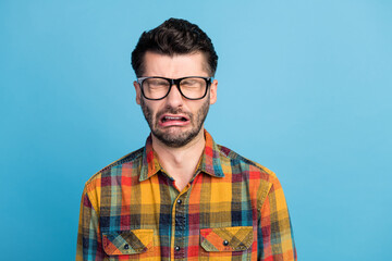 Obraz premium Photo of stressed brunet guy crying wear eyewear yellow shirt isolated on blue color background