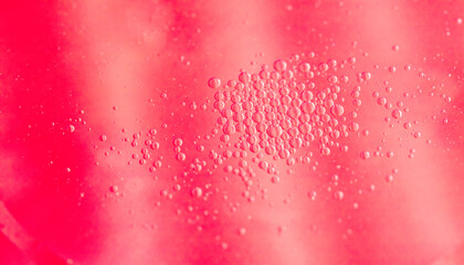 small drops of oil in water on red background. abstract texture 