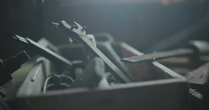 Closeup view of old vintage tools with wrenches inside in old dusty garage